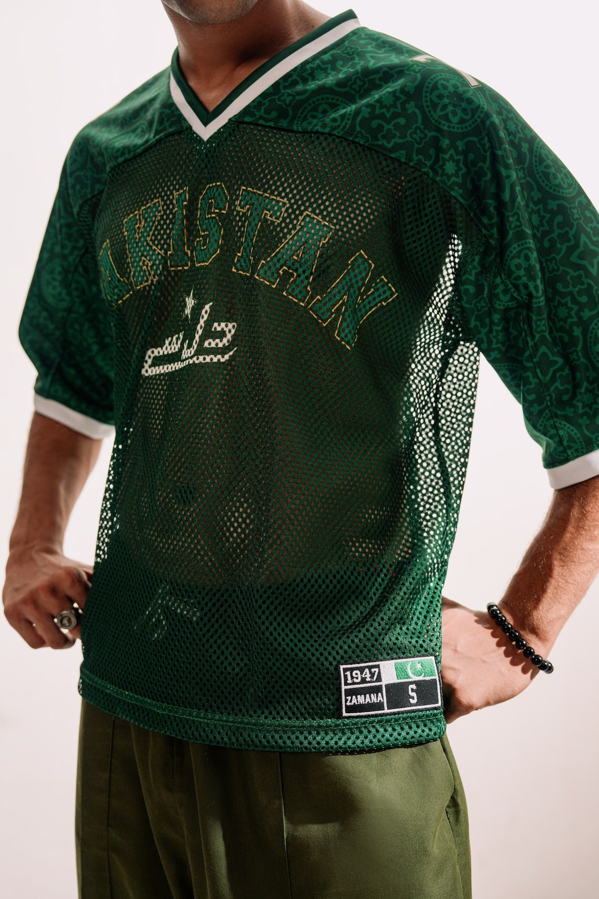 model:detail model:studio | Green Passport jersey — mesh and 1947 ZAMANA label detail