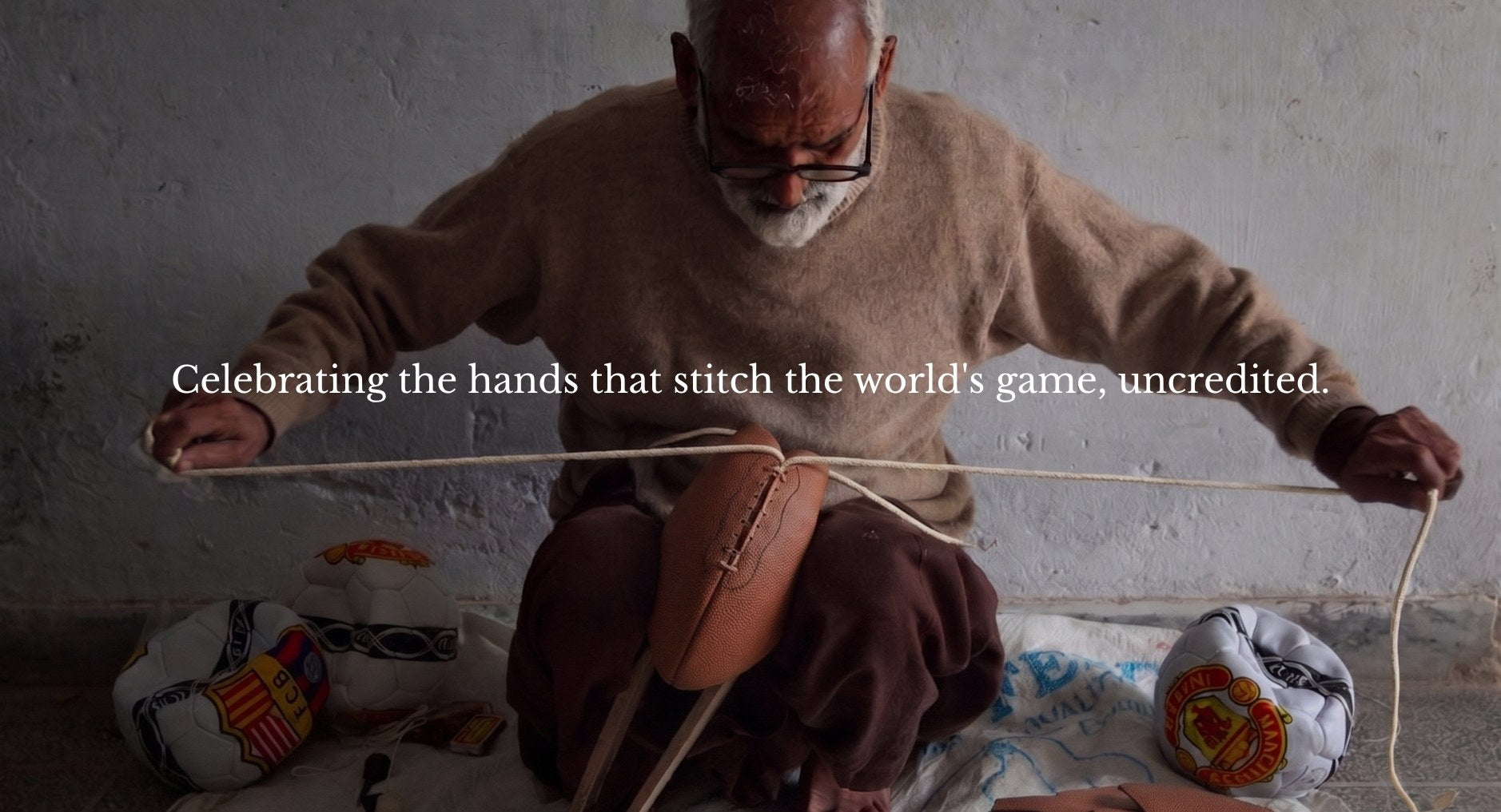 Craftsman hand-stitching a football on the floor beside finished balls, overlaid with the line “Celebrating the hands that stitch the world’s game, uncredited.”