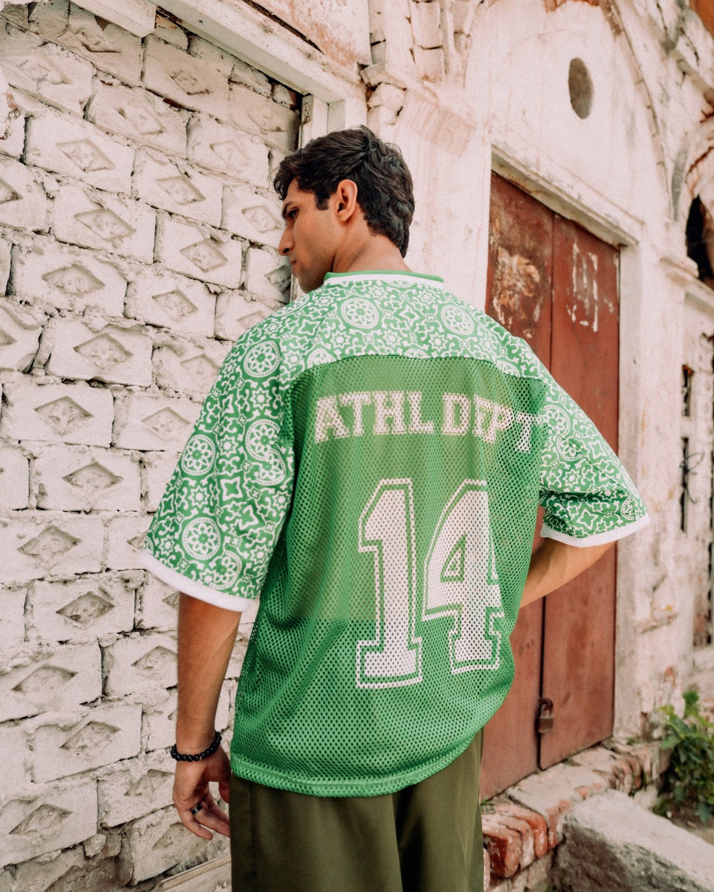 Pakola Green jersey worn from behind, ATHL DEPT 14 across the back — Athletic Department campaign, Lahore